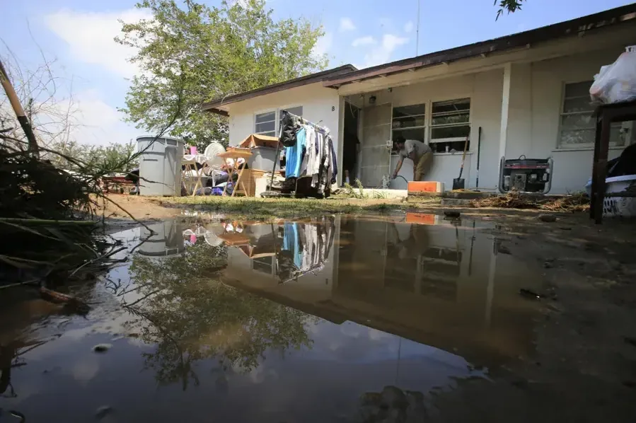 Storm water pooled around a single-story home after heavy rain